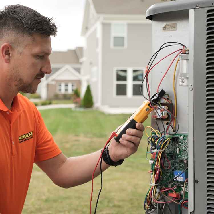 Summers technician checking an ac unit.