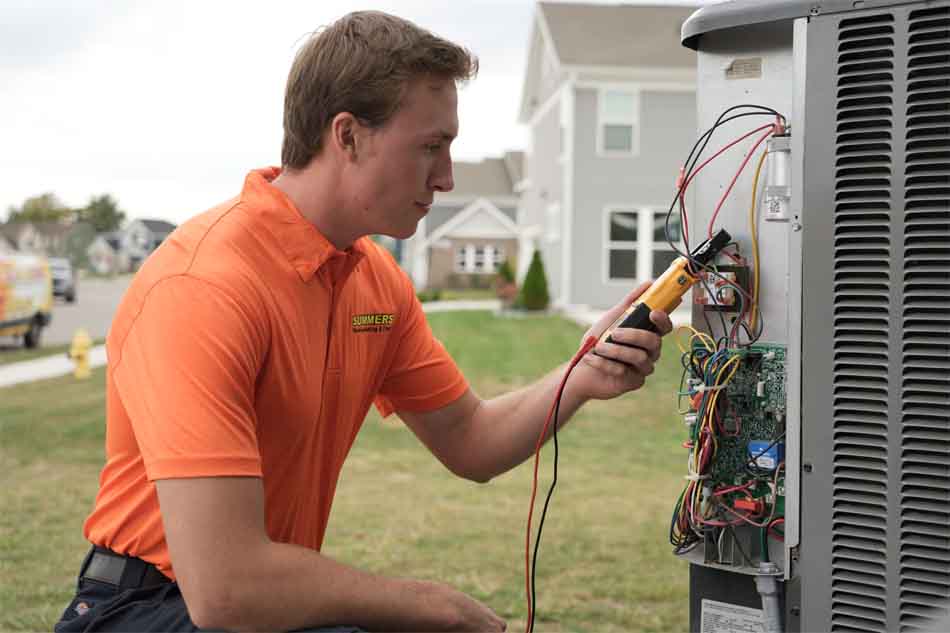 Summers Technician operating on an AC unit