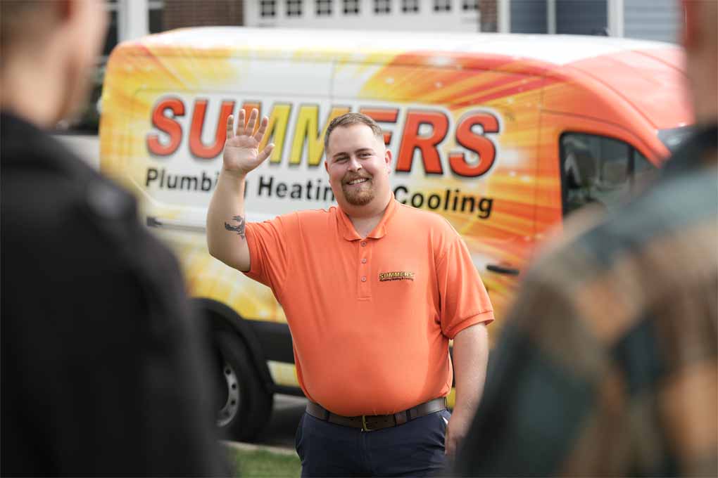 Summers technician waving to customers
