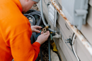 Summers Plumbing technician repairing an outdoor hose bib at a Huntington, IN home