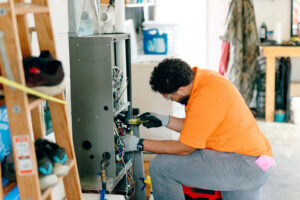 Summers technician performing a furnace tune-up inspection in a Marion, Indiana home