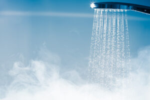 Prepare your water heater for spring. Steamy shower head image.