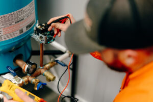 ummers Plumbing technician testing well pressure switch and pressure tank during a residential well inspection