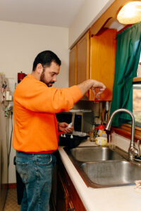 Summers PHC technician performing a well water quality test with a test kit at a Peru, Indiana home's kitchen sink